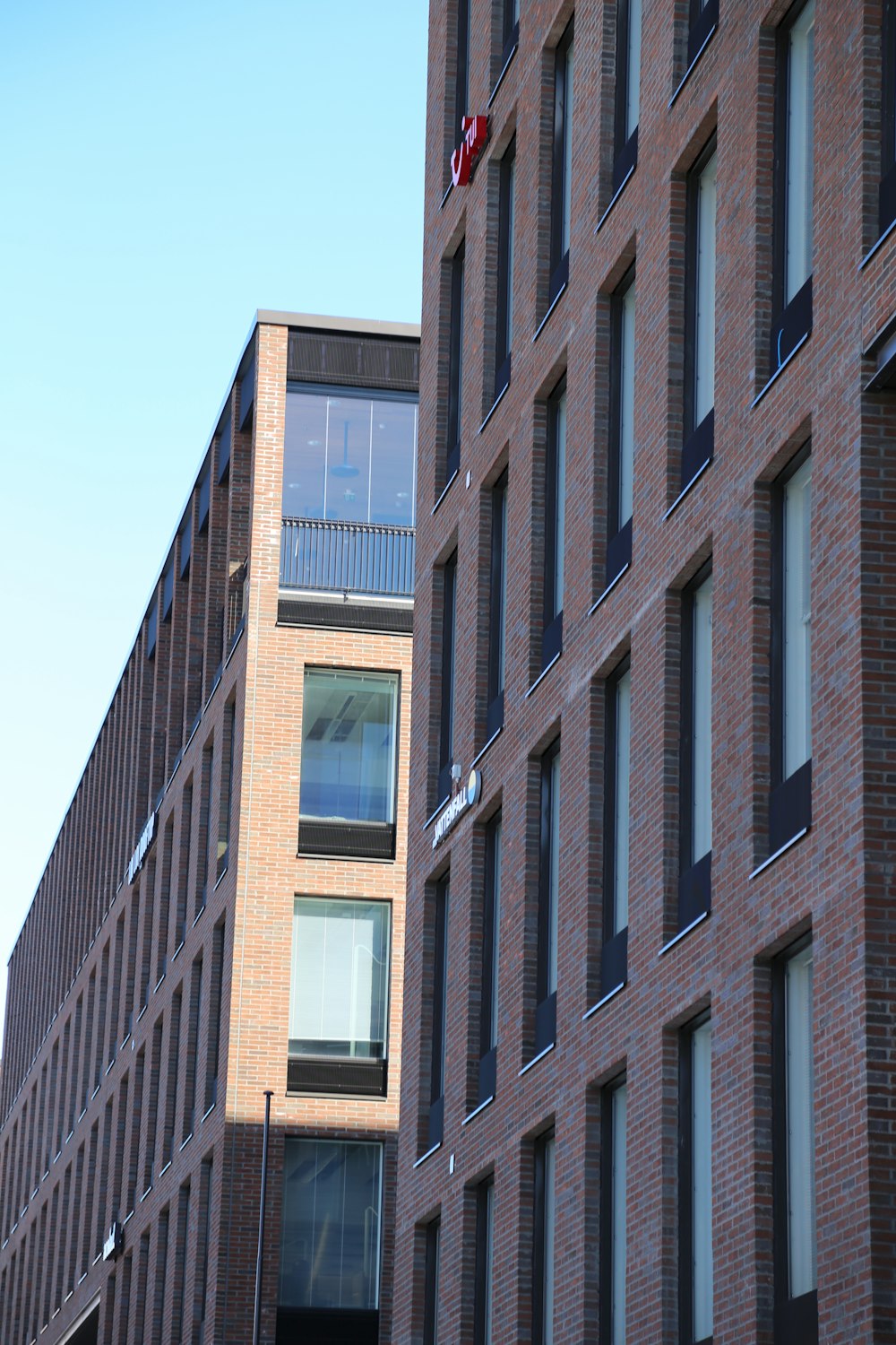 a tall brick building next to a tall brick building