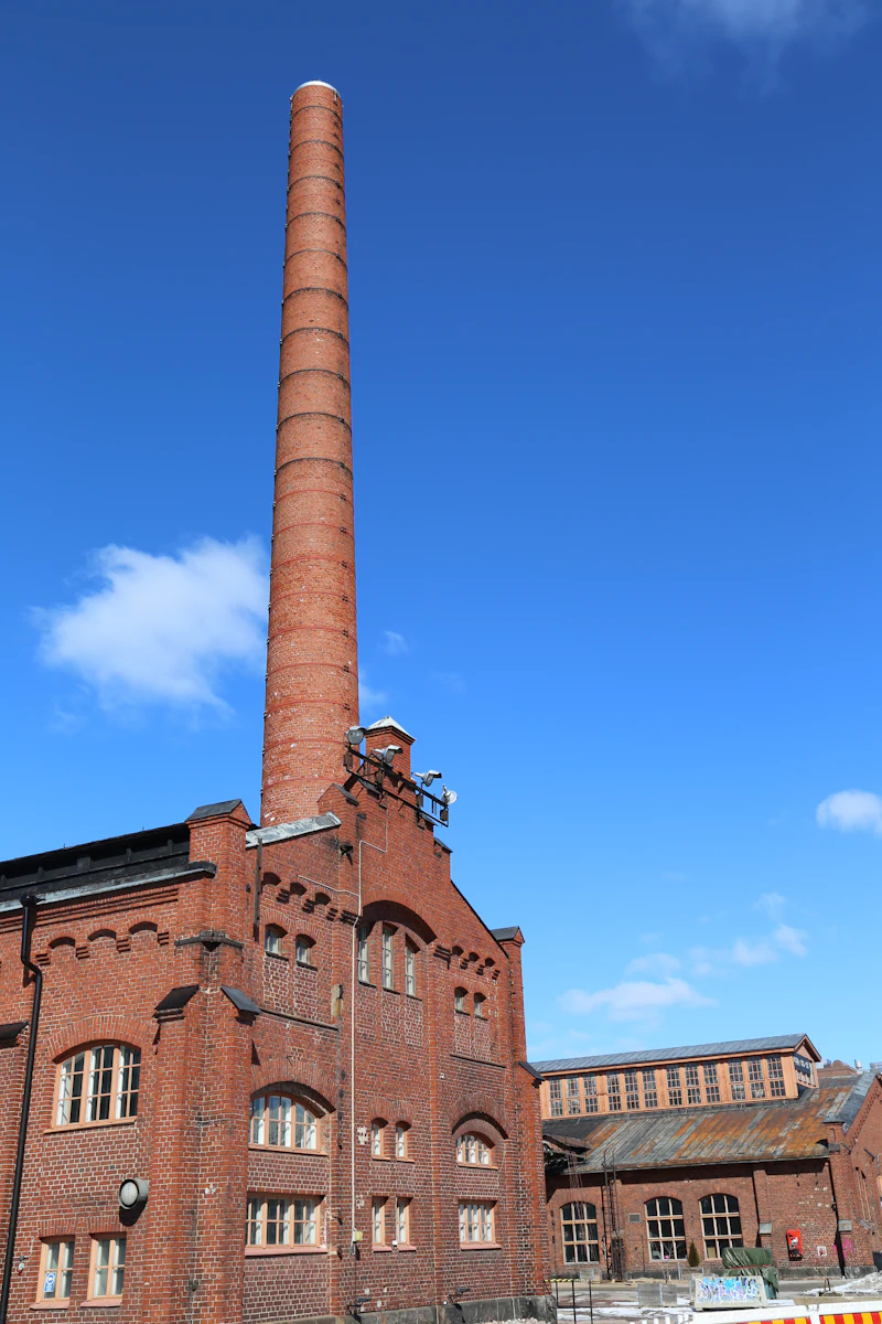Old brick industrial building with tall chimney