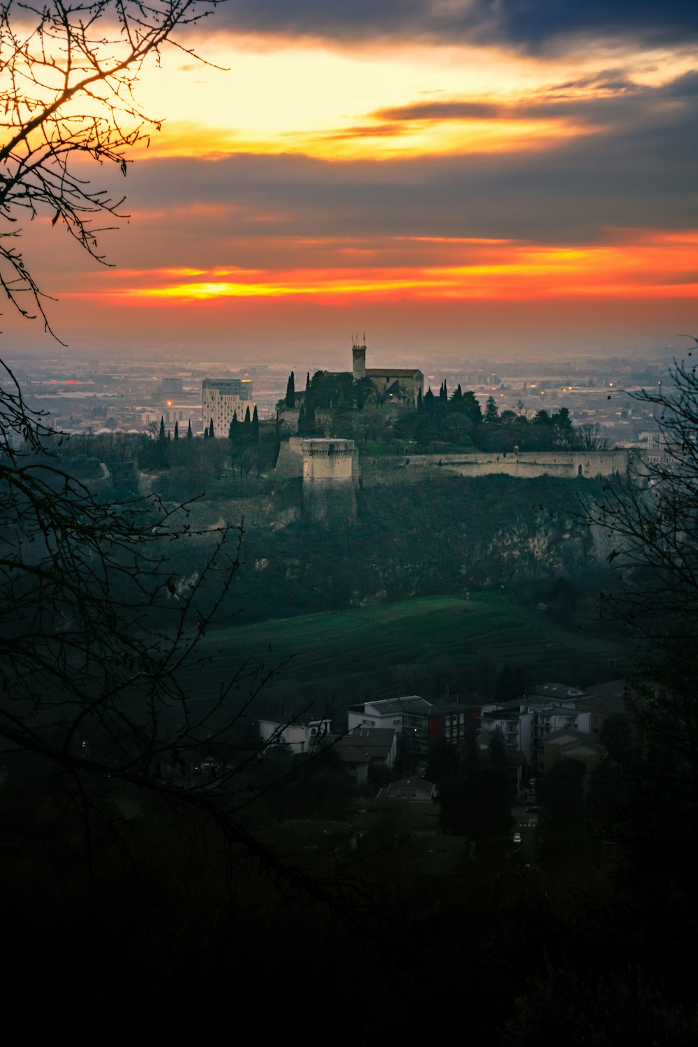 a sunset view of a castle in the distance