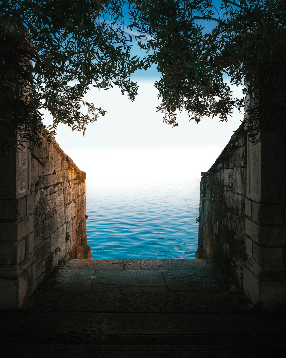 a view of the ocean through an archway