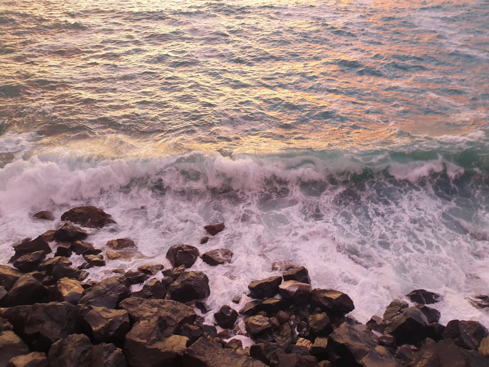 a view of a body of water with rocks in the foreground