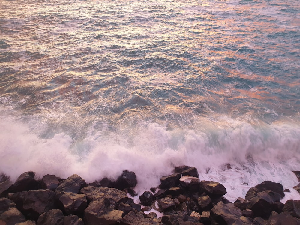 a view of a body of water with rocks in the foreground