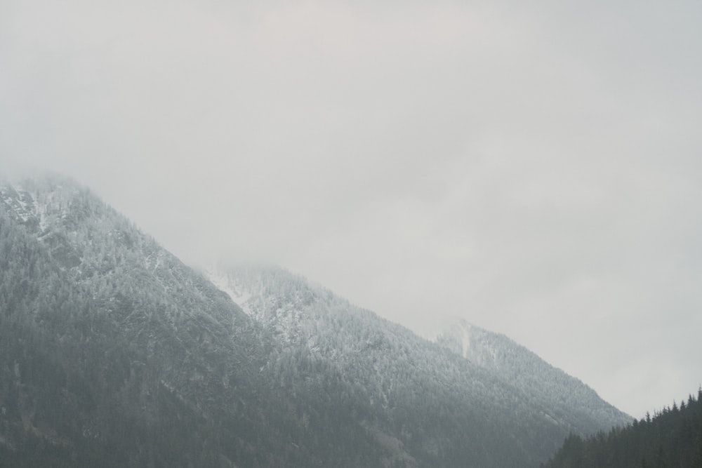 a mountain covered in snow on a cloudy day