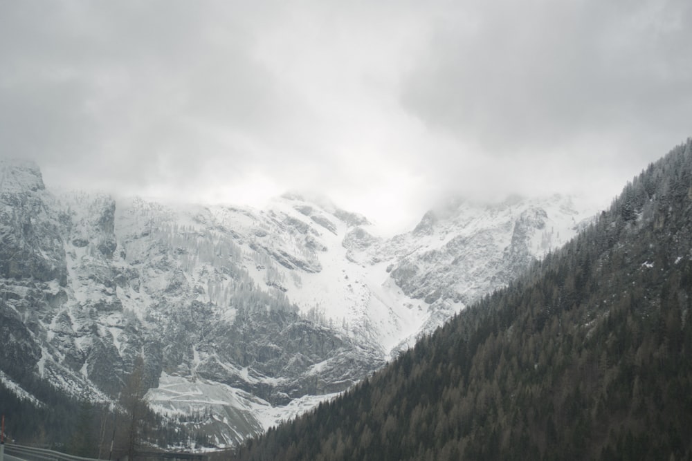 a view of a snowy mountain range from a highway