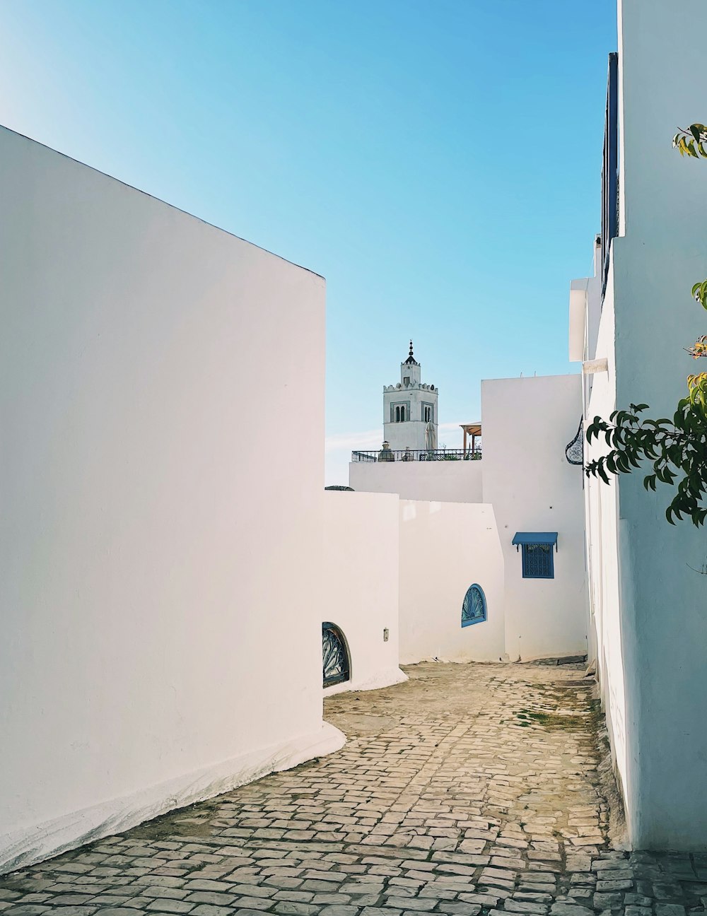 a white building with a bell tower on top of it