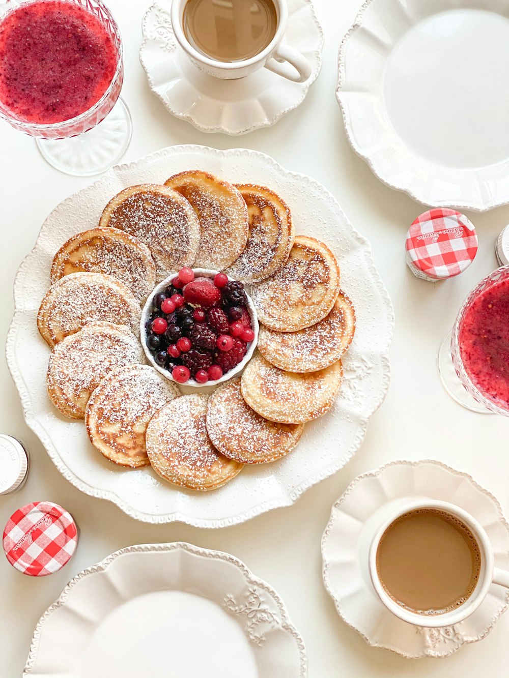 a white plate topped with powdered sugar covered pastries