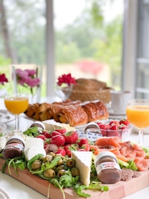 a tray of food on a table with a glass of orange juice