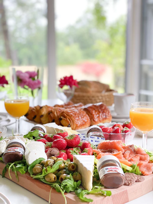 a tray of food on a table with a glass of orange juice