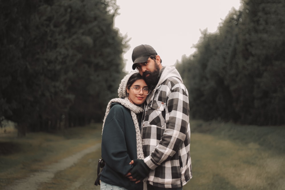 a man and a woman standing in a field