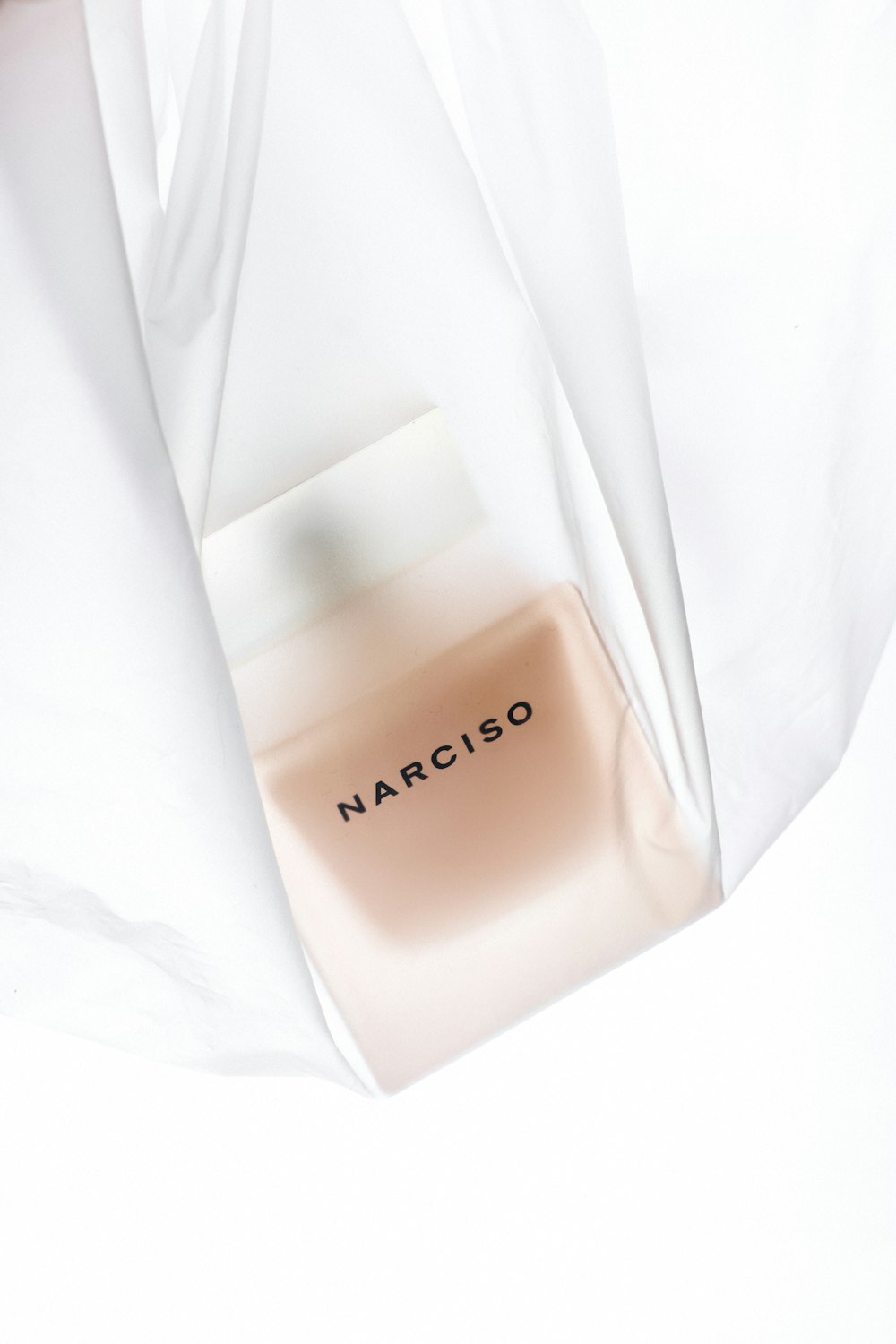 a bottle of narciso on a white sheet
