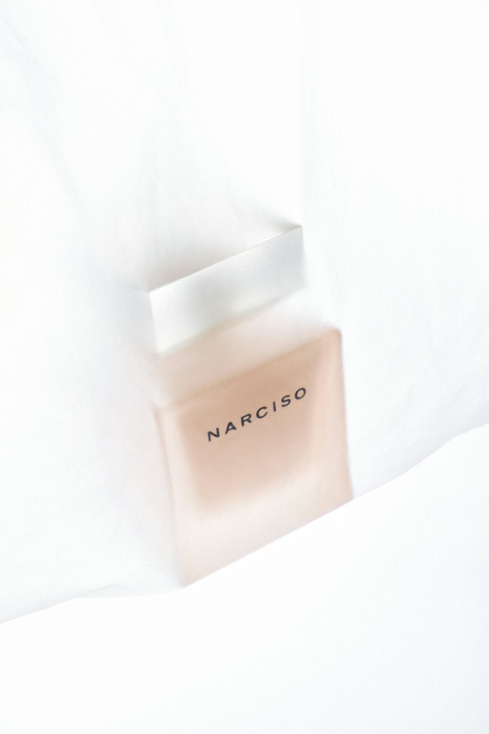 a bottle of narciso on a white sheet