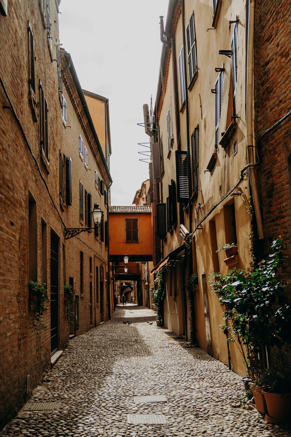 a narrow cobblestone street in an old european city