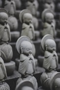 a group of buddha statues sitting next to each other