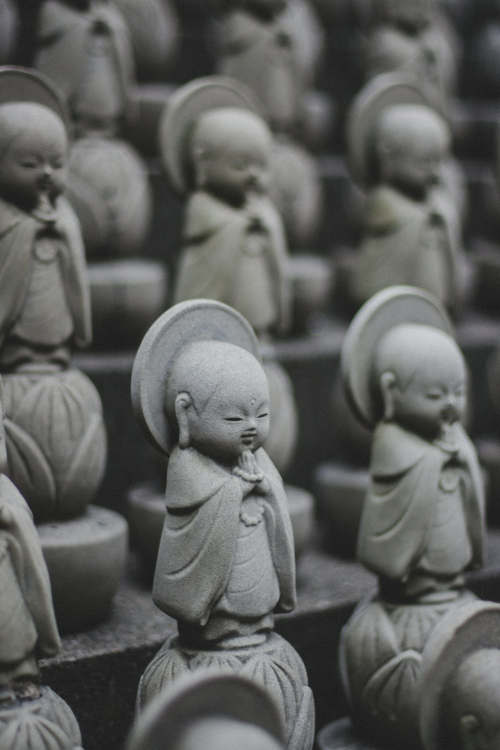 a group of buddha statues sitting next to each other