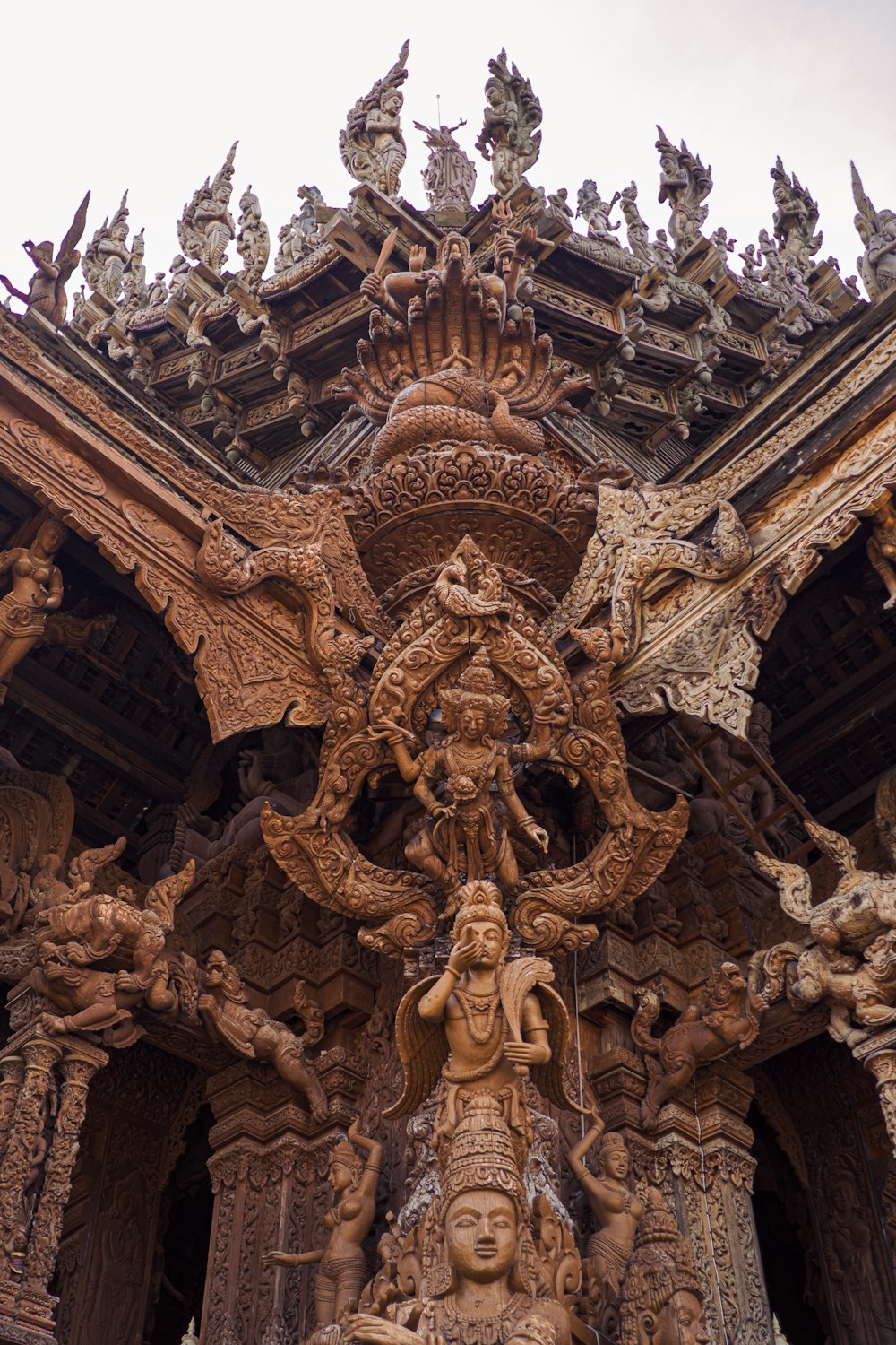 a statue of a person with many faces on it