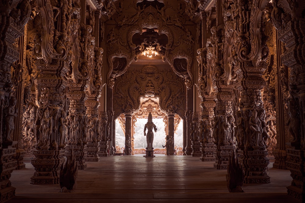 a person standing in a large room with columns