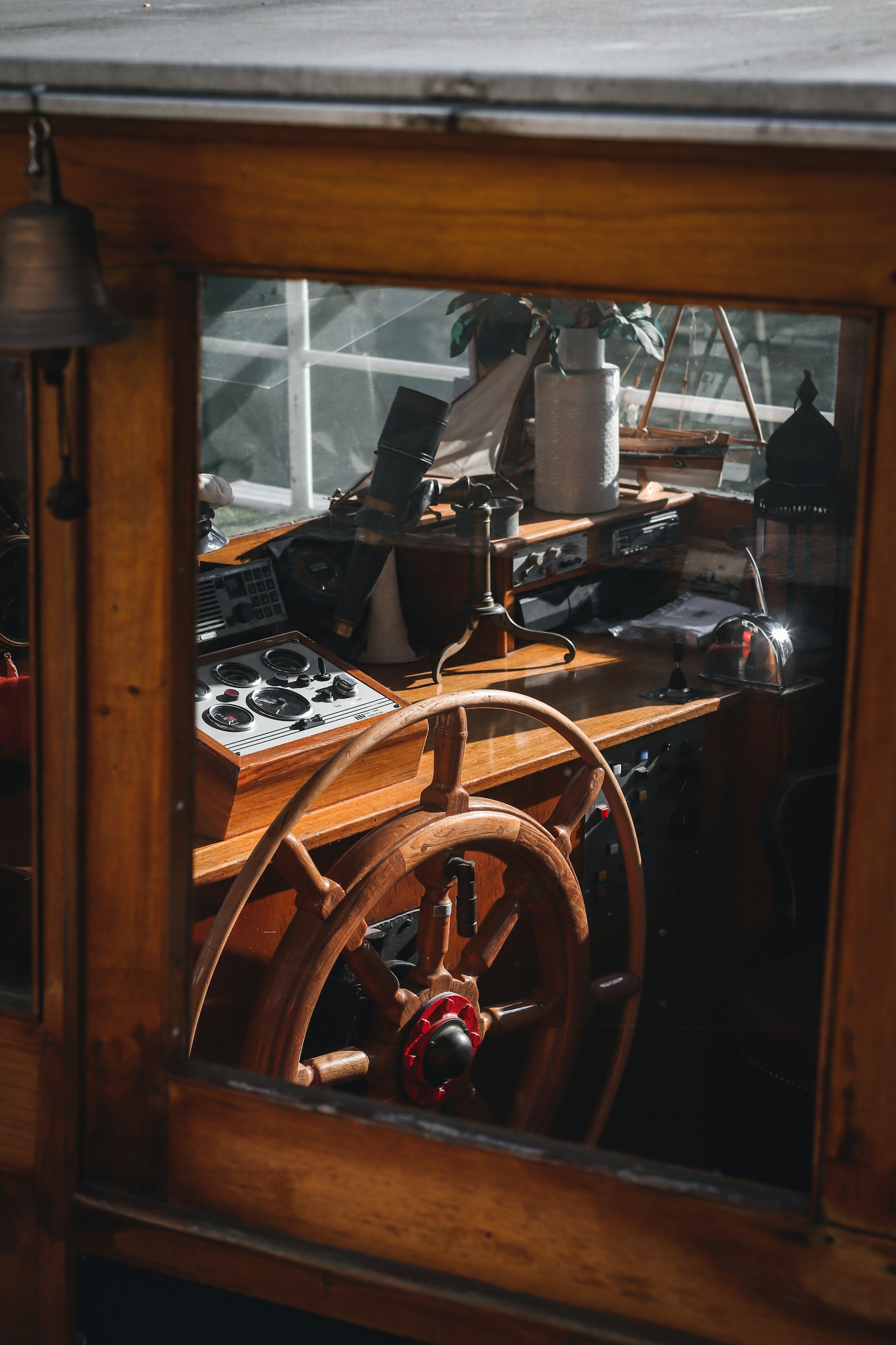 a boat with a steering wheel in a window
