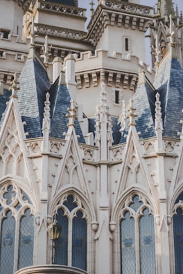Detailed architectural design featuring intricate spires, ornate patterns, and neo-gothic elements with blue-tiled roofs and pointed arches.