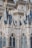 Detailed architectural design featuring intricate spires, ornate patterns, and neo-gothic elements with blue-tiled roofs and pointed arches.