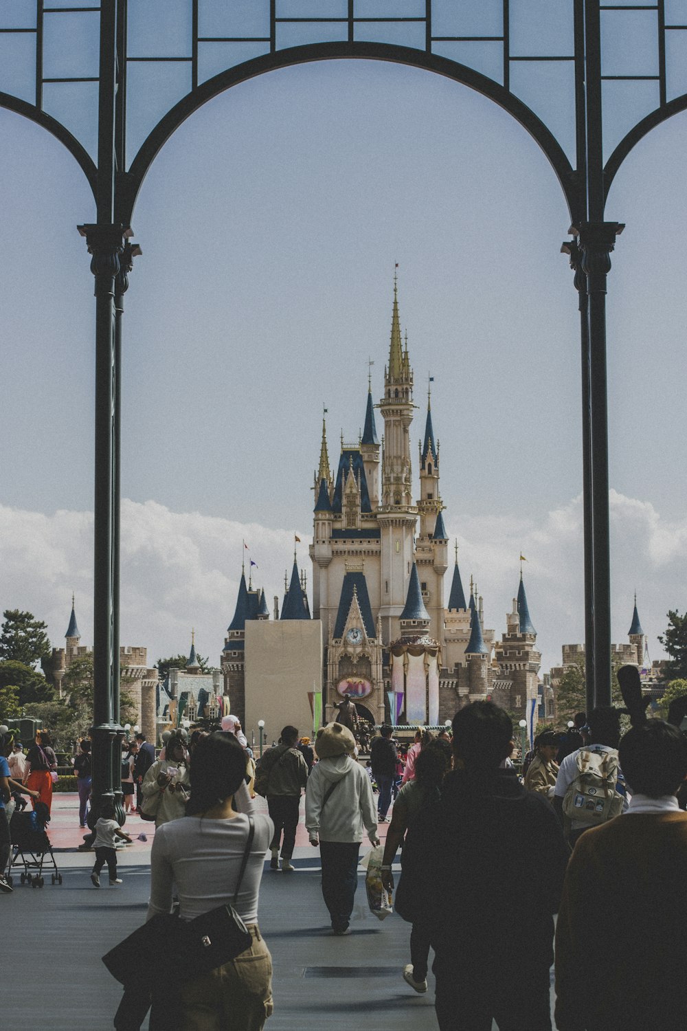 a group of people walking in front of a castle