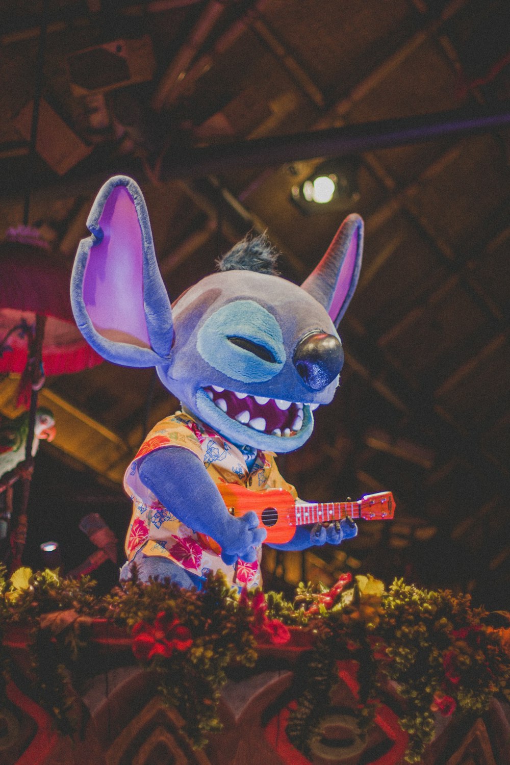 a stuffed animal with a guitar in it's mouth