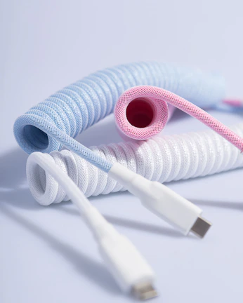 A neatly coiled set of colorful electrical cables displayed on a white background.