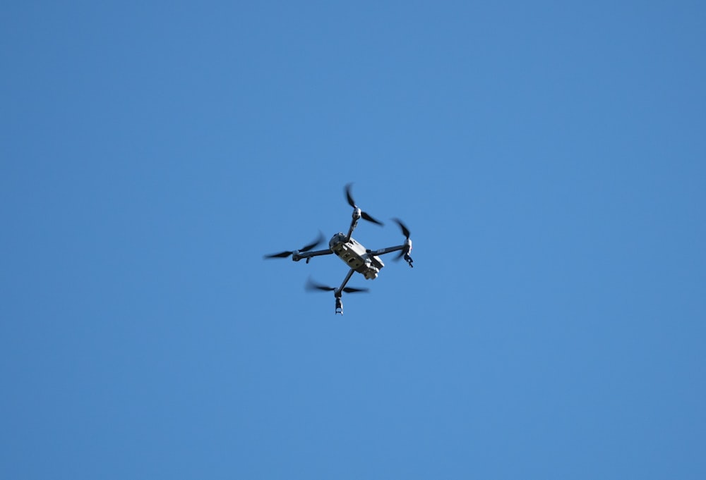 a small propeller plane flying through a blue sky