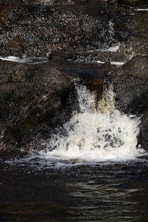 A gentle waterfall flowing over rocks, symbolizing cleansing and renewal