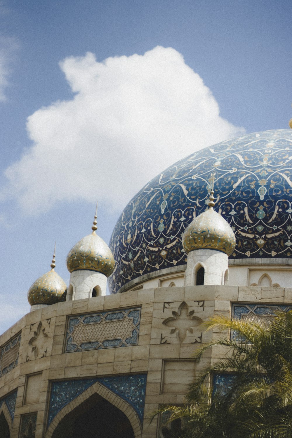 a large building with a blue and gold dome