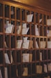 a bunch of papers are on a wooden shelf