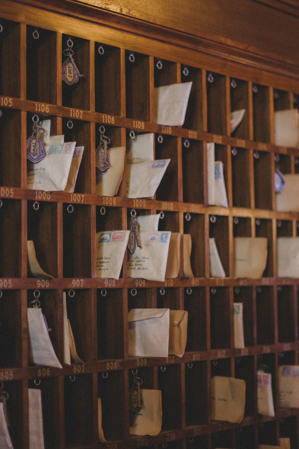 a bunch of papers are on a wooden shelf