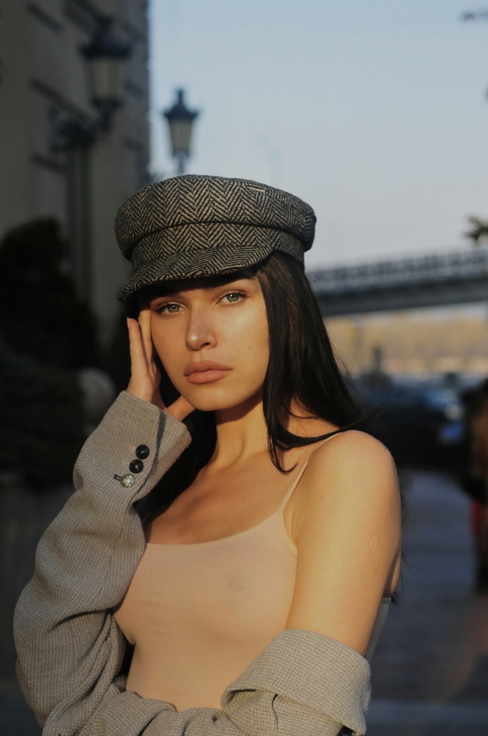 a woman wearing a hat is posing for a picture