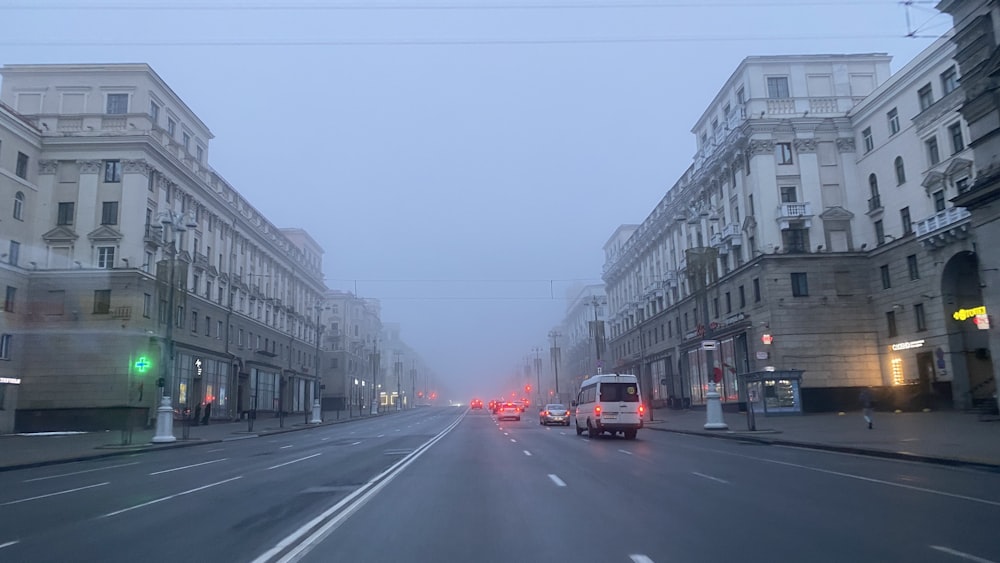 a city street filled with traffic next to tall buildings