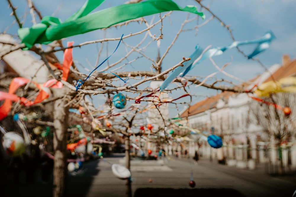 a bunch of kites that are hanging from a tree