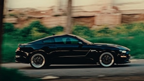 A sleek red sports car speeding on an open road at sunset, capturing energy and motion