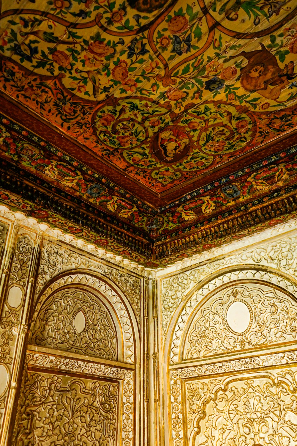 a decorative ceiling in a building with gold paint