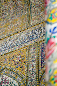 Detailed shot of colorful wall painting with floral patterns indoors.
