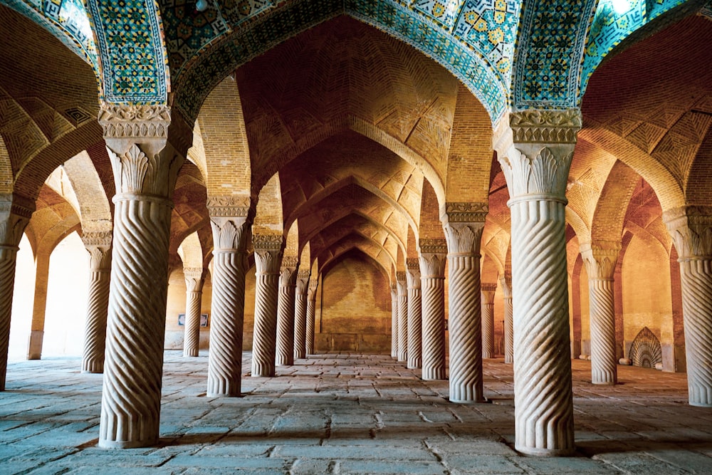 a large room with many pillars and arches