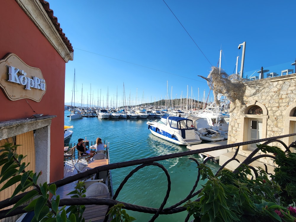 a harbor filled with lots of boats next to a building