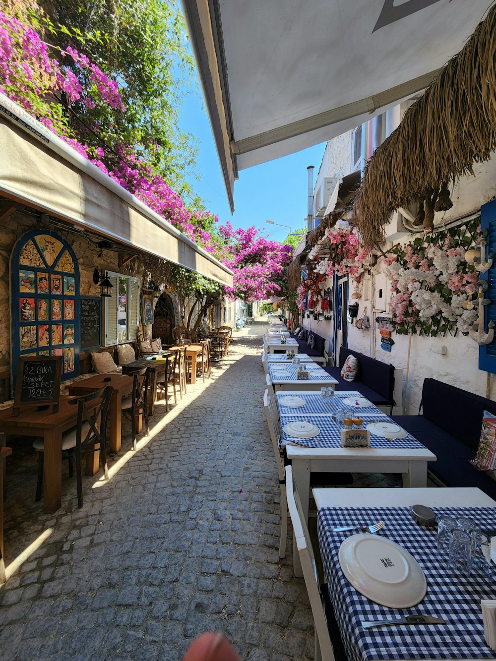 a row of tables with blue and white checkered tablecloths