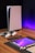 A sleek, modern setup featuring a gaming console with two controllers on a wooden surface. Nearby are a smartphone, smartwatch, tablet with a vivid screen, wireless earbuds, and a stylus. The background is illuminated with a soft purple glow.