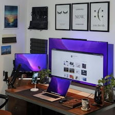 A modern workspace with multiple digital devices displaying interconnected applications.