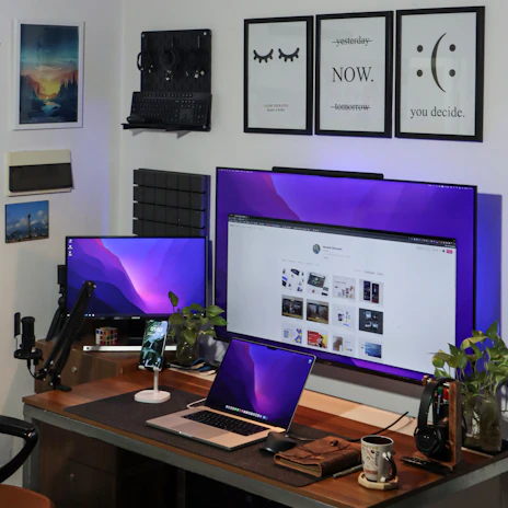 A modern workspace with multiple devices showing tech news and updates on screen.
