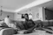 Happy man checking products on a smartphone in a cozy living room