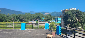 A serene rooftop garden with rainwater harvesting tanks under a clear blue sky.