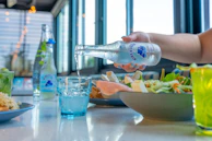 A beautifully set corporate lunch table with fresh salads, sandwiches, and sparkling water.