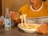 a man eating a bowl of noodles with a bottle of water