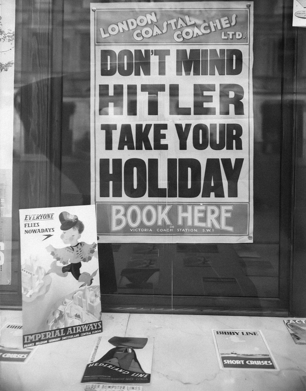 a black and white photo of a sign in a window