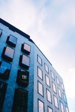 Contemporary glass facade on a commercial building with blue sky.