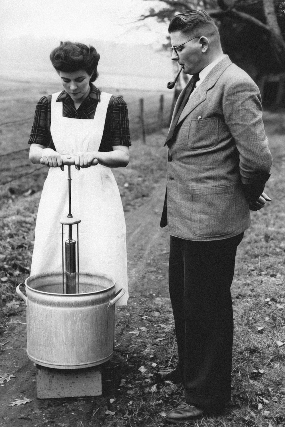 a man and a woman standing next to a barrel